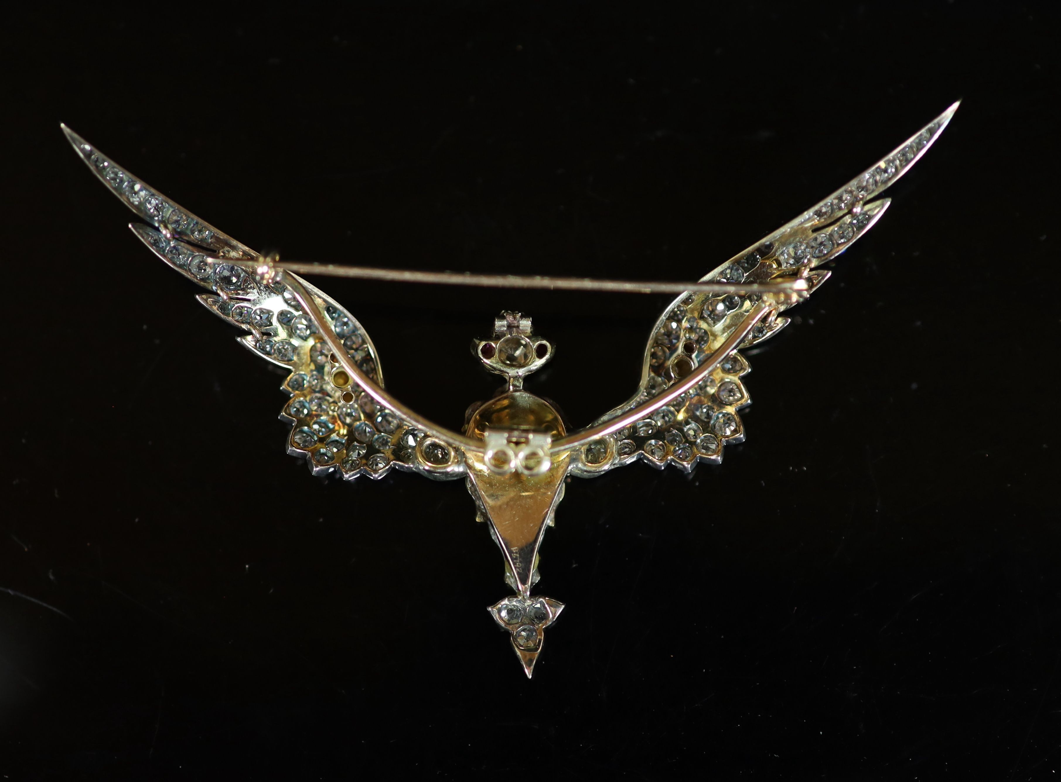 A late Victorian gold, foil backed pear cut ruby and old mine cut diamond encrusted brooch, modelled as a Phoenix